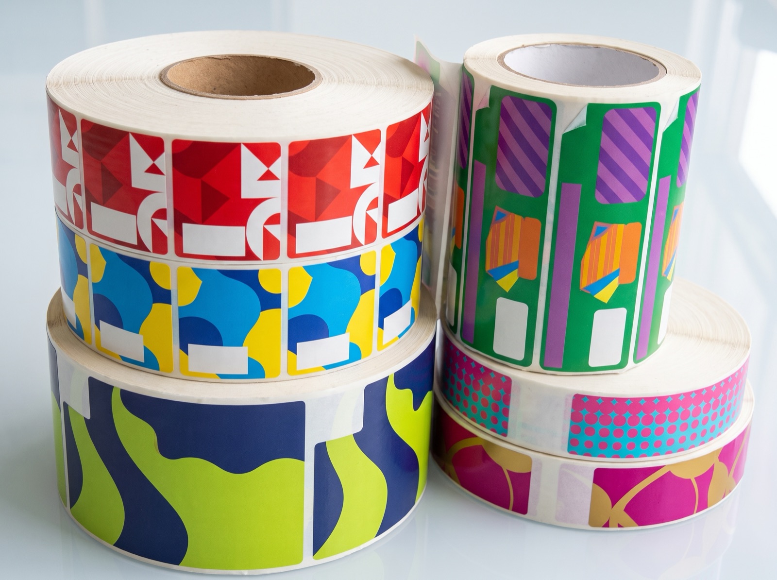 Custom printed product label roll on a studio backdrop, made by Euphora