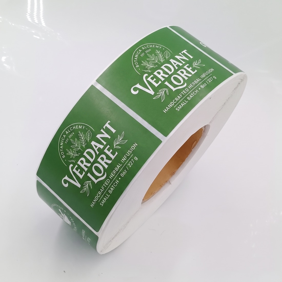 Custom printed product label roll on a studio backdrop, made by Euphora