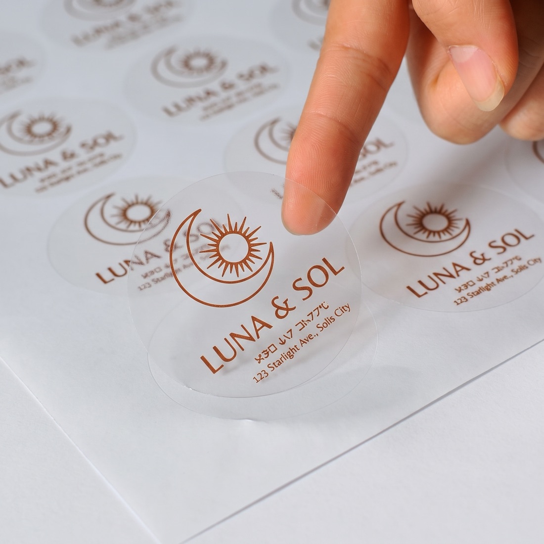 Custom printed product label roll on a studio backdrop, made by Euphora