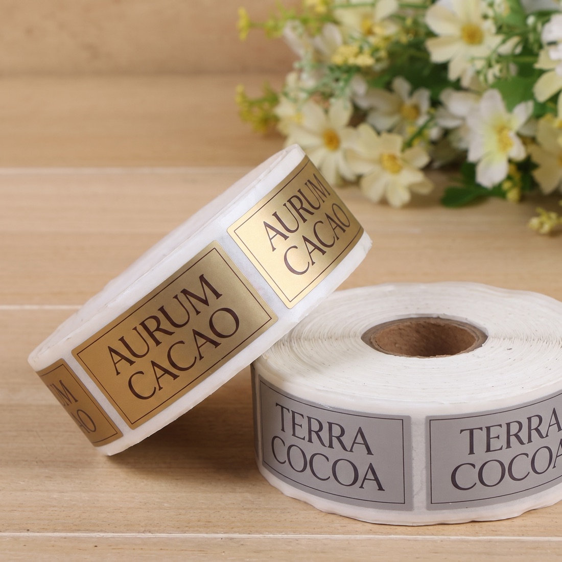 Custom printed product label roll on a studio backdrop, made by Euphora