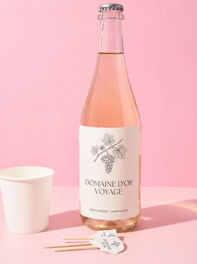 Blush rose wine bottle with an elegant custom label, pink editorial