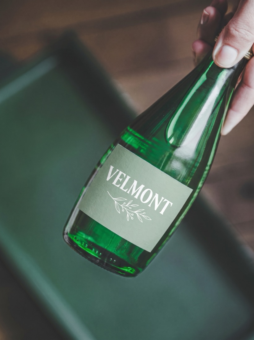 Green glass sparkling bottle with an elegant custom label